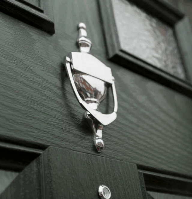 Urn style silver knocker on a composite door